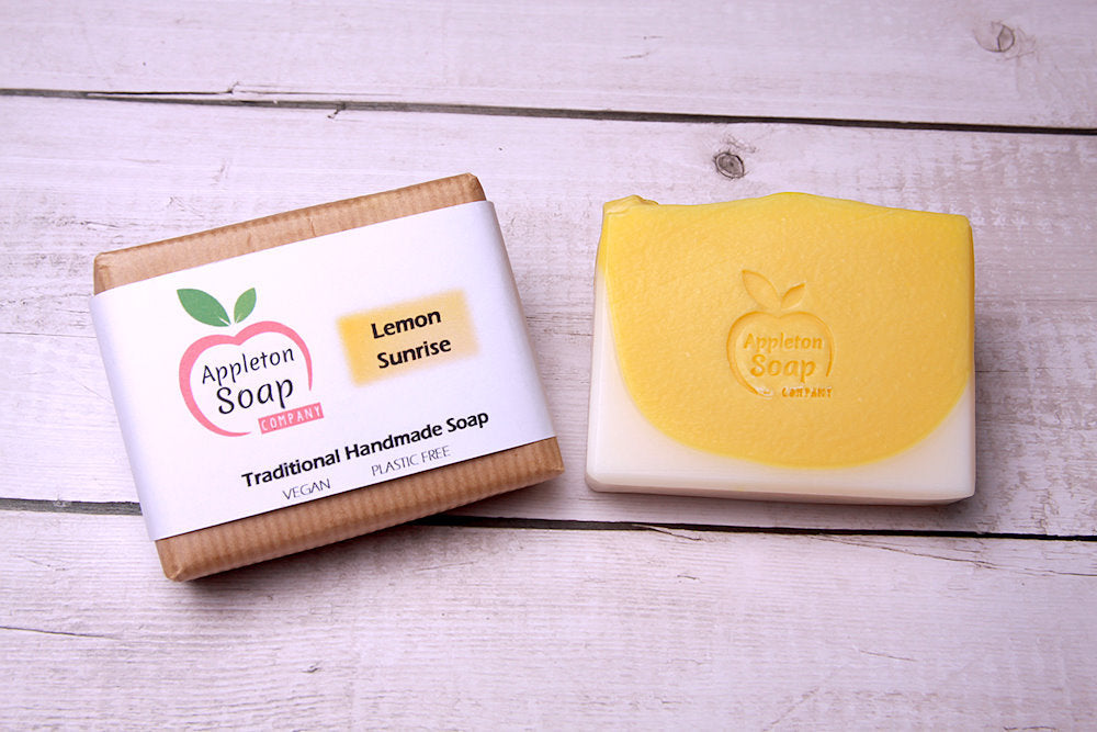 Lemon sunrise soap bar next to wrapped bar