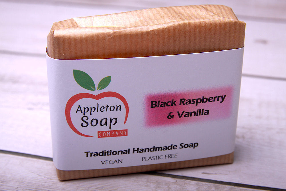 Black raspberry and vanilla soap bar wrapped in brown paper with a white band label