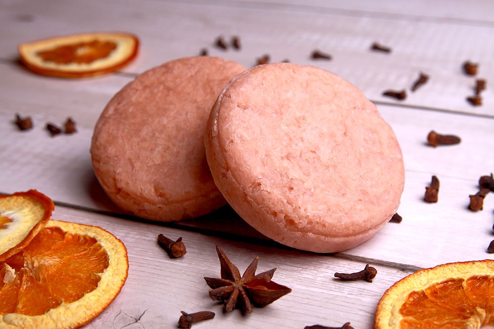 Christmas spice shampoo bars shown with dried orange slices, Cloves and star of anise.