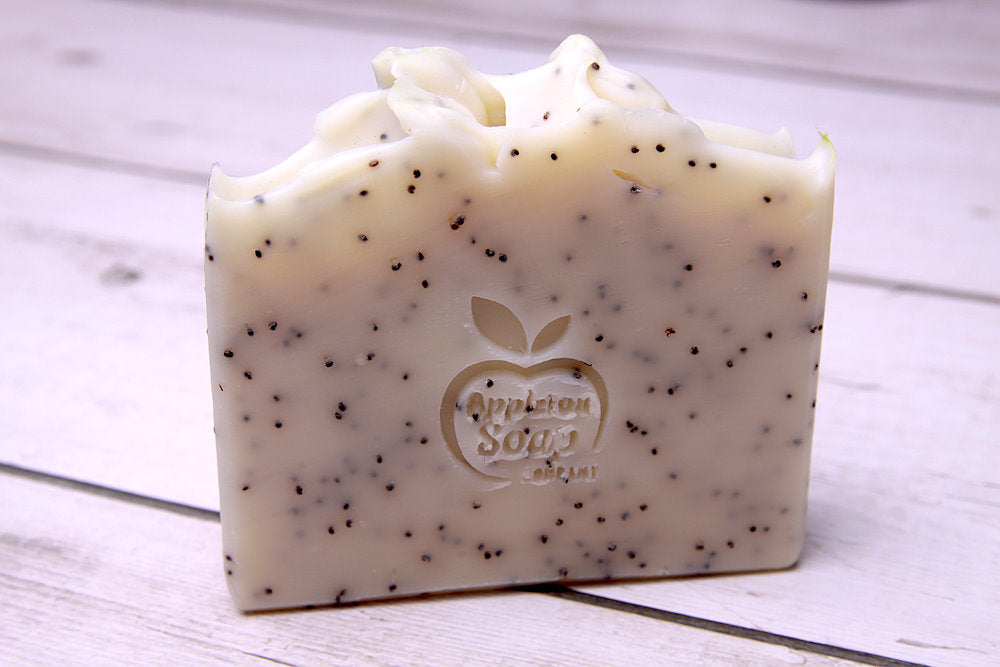 Citrus scrub soap bar, cream in colour with poppy seeds