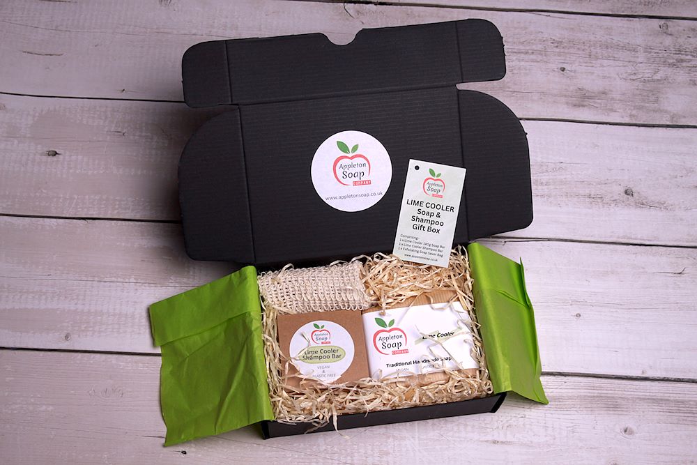 Black cardboard giftbox with paper and card wrapped Lime cooler shampoo and handmade soap bar. Sisal soap recycle bag included. Wrapped in green tissue paper with recyclable packaging