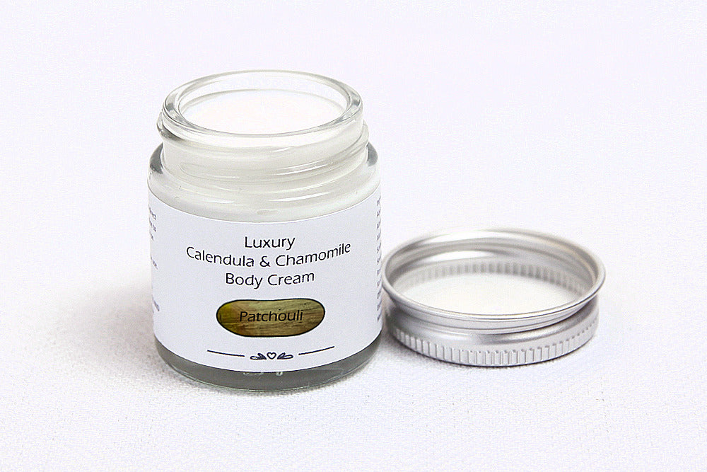 Luxury Patchouli Body cream in open glass jar with metal lid