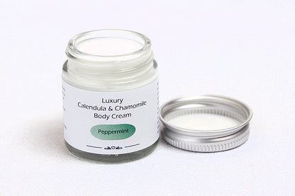 Luxury Peppermint Body cream in open glass jar with metal lid