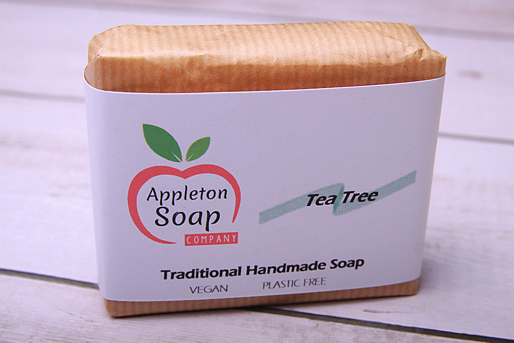 Tea tree soap bar wrapped in brown paper with white banded label