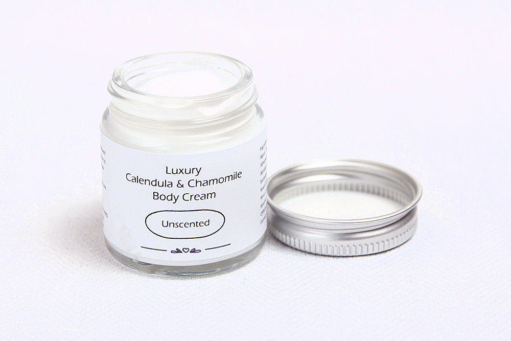 Luxury Unscented Body cream in open glass jar with metal lid