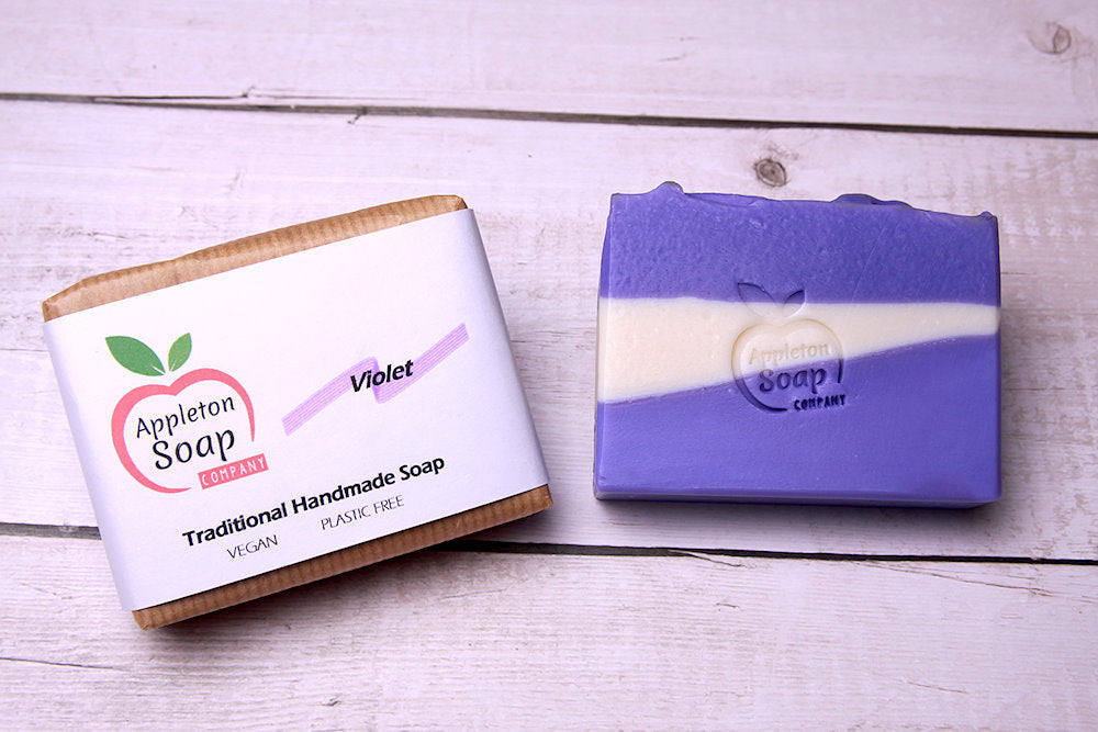 Violet soap bar next to wrapped bar