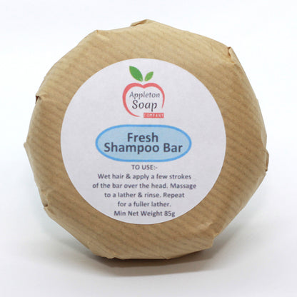 Fresh shampoo bar wrapped in brown paper with white label