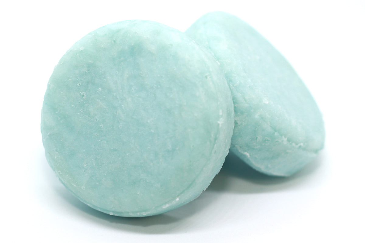 Fresh shampoo bars, round and light blue / green in colour